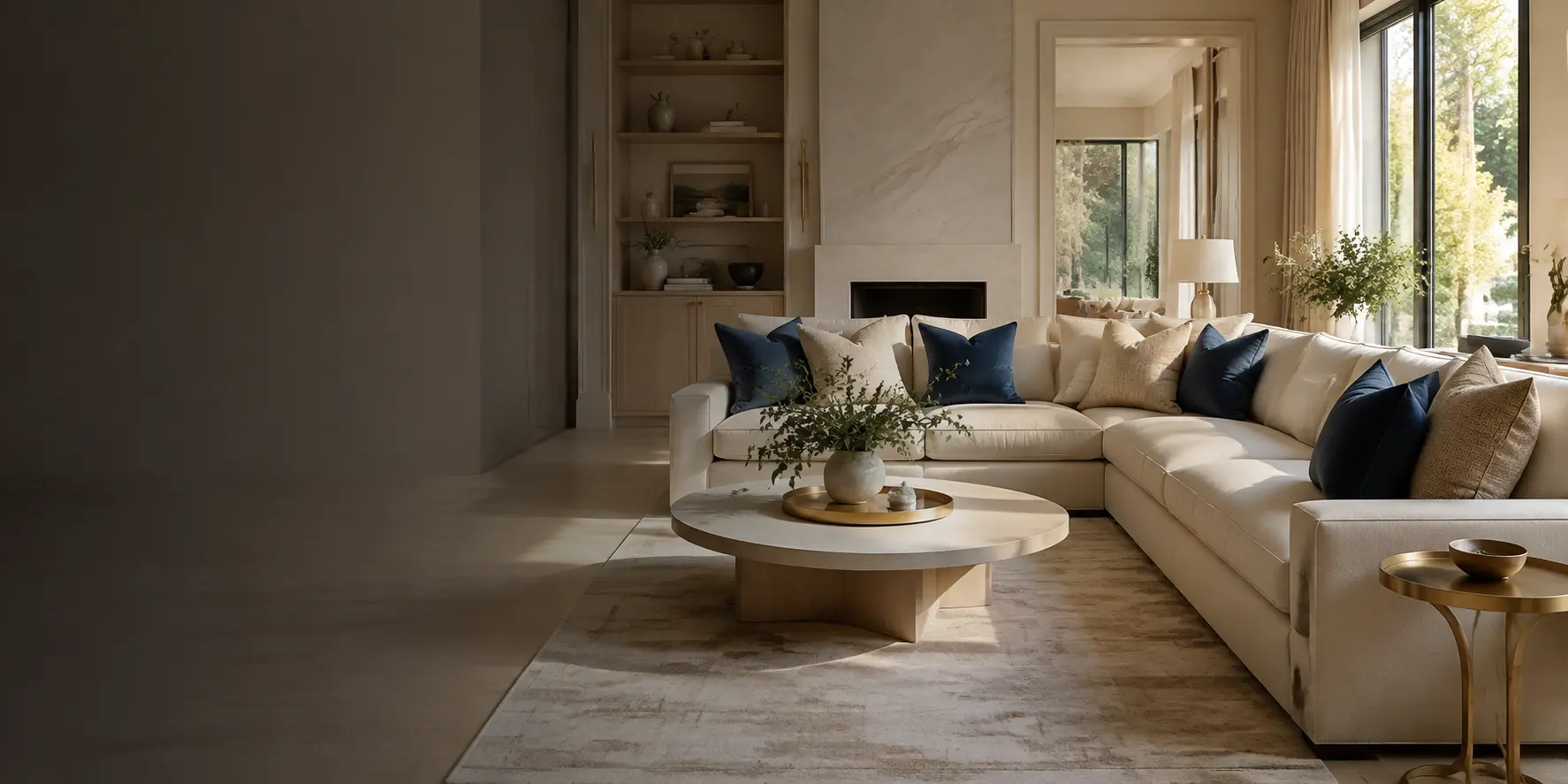 Serene, immaculate living room with warm ivory furnishings and navy accents